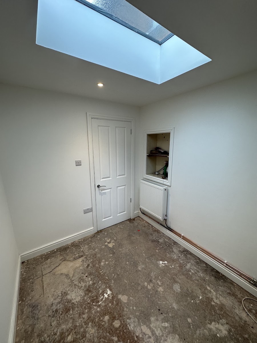 Interior room finished by MJJ with a roof light, fresh walls and fitted radiator